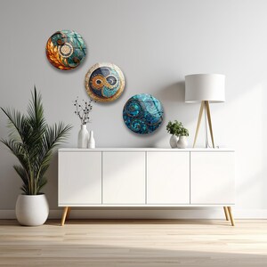 a modern, minimalist living room with a white cabinet, a lamp, and three decorative plates on the wall.