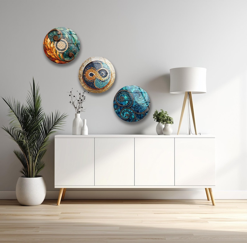 a modern, minimalist living room with a white cabinet, a lamp, and three decorative plates on the wall.