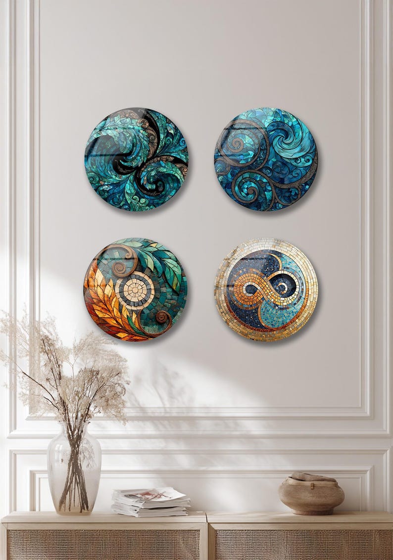 four decorative plates hanging on a wall, each with a unique design and color scheme.