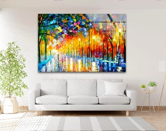 May include: A colourful abstract painting of a street lined with trees. The trees are painted in shades of blue, green, yellow, orange, and red. The street is wet and reflective, and there are people walking in the distance. The painting is done in a loose, impressionistic style.