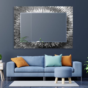 a living room with a blue couch and a mirror