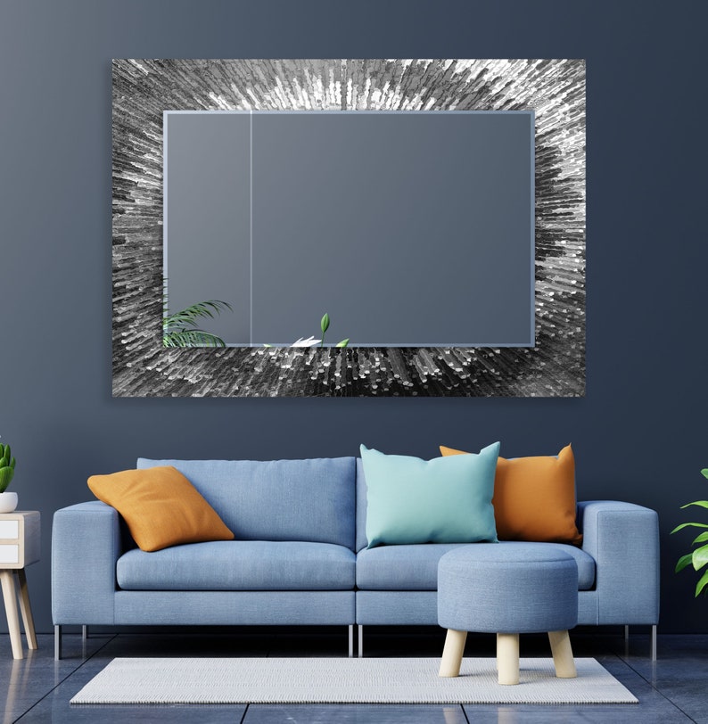 a living room with a blue couch and a mirror