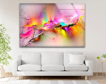 May include: A large, rectangular abstract art print with a vibrant display of colours. The artwork features a dynamic composition of pink, yellow, green, and blue hues, creating a sense of movement and energy. The print is displayed above a white sofa.