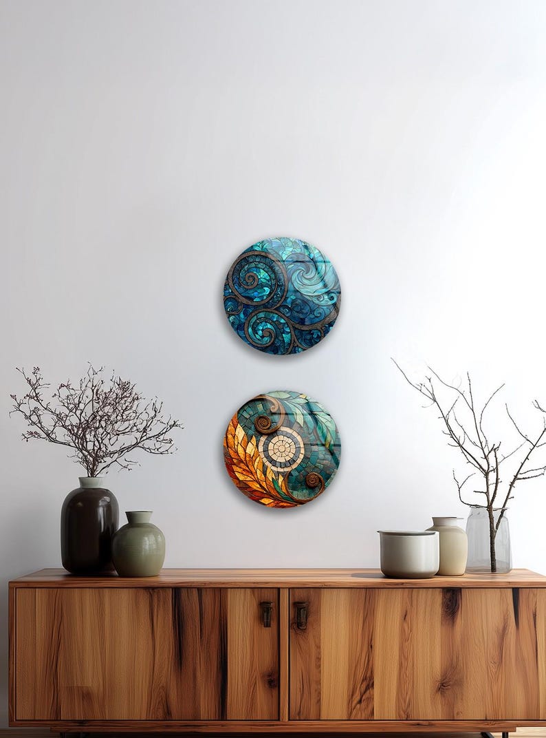 a wooden cabinet with two decorative plates hanging on the wall above it. The cabinet has a dark brown finish and is adorned with various decorative items, including two vases, a small plant, and a bowl.
