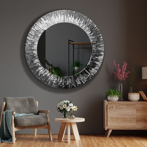 a living room with a chair and a round mirror