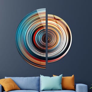 May include: Abstract wall art featuring two circular panels with concentric rings of blue, orange, red, and white. The panels are split vertically and create a modern, geometric design.