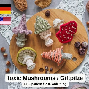 May include: A collection of handmade crochet mushrooms in various colors, including purple, green, red, and orange, displayed on a wooden board. The mushrooms have detailed caps and stems, with some featuring white spots. The text "toxic Mushrooms / Giftpilze" is visible.