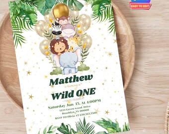 May include: A green and gold jungle-themed first birthday party invitation with a cartoon elephant holding a lion and giraffe. The invitation says "Matthew is turning a Wild One" and includes the date, time, and location of the party.