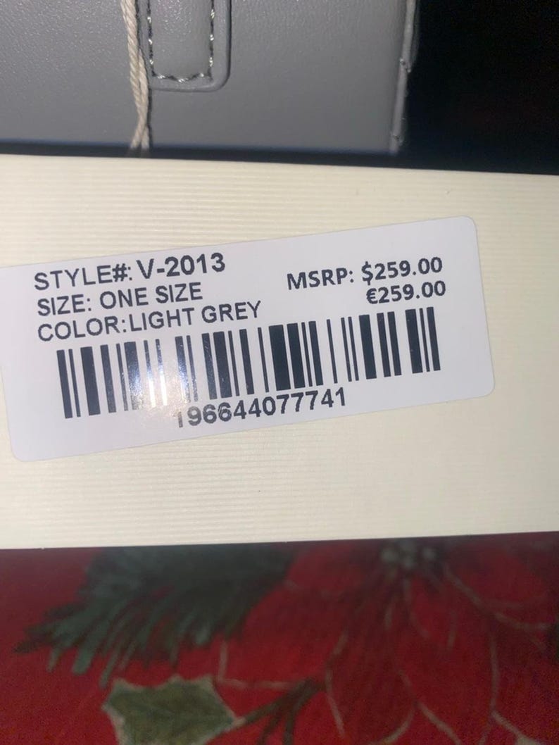 May include: A light grey product label with the text "STYLE#: V-2013", "SIZE: ONE SIZE", and "COLOR: LIGHT GREY". The label also includes a barcode and the number "196644077741".