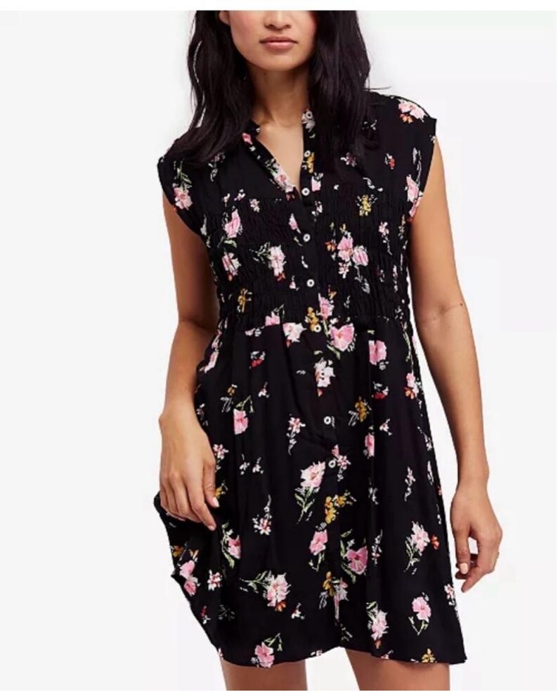 May include: A black short-sleeved dress with a floral print in shades of pink, yellow, and green. The dress has a button-up front and a cinched waist.