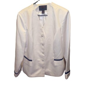 May include: A white blazer with a V-neck, featuring navy blue trim on the pockets and cuffs. The blazer has a button-up front and is hanging on a black hanger. The label reads "Retro".