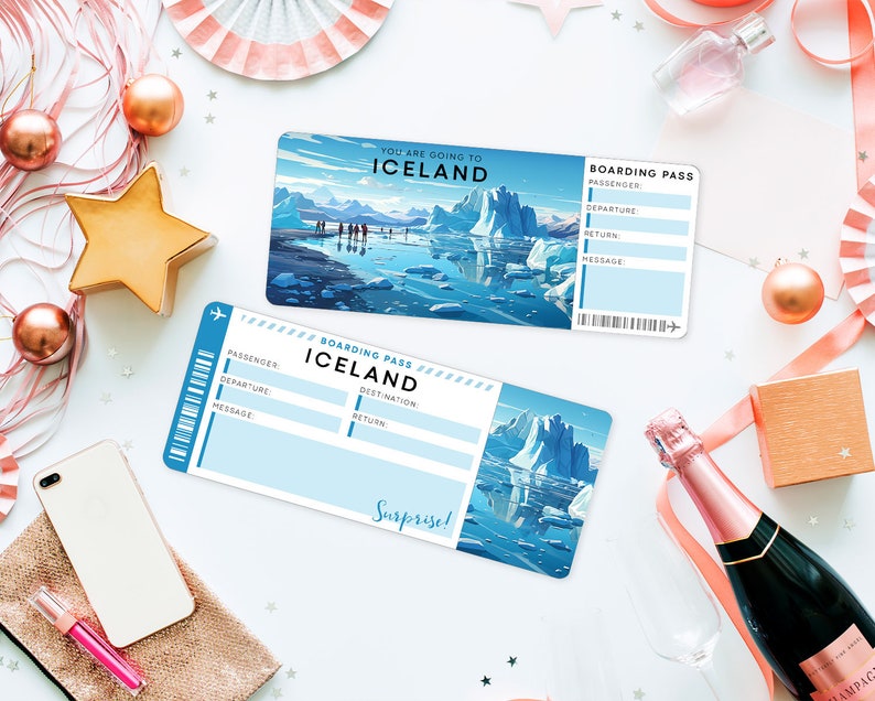 May include: Two blue and white boarding passes with the text "You are going to Iceland" and "Boarding Pass Iceland" on them. The passes are on a white surface with gold stars, pink ribbon, and a champagne bottle.