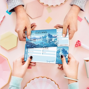 May include: Two people holding a blue and white boarding pass with the text "You are going to Iceland" and "Boarding Pass". The pass has a picture of a glacier and a sailboat.