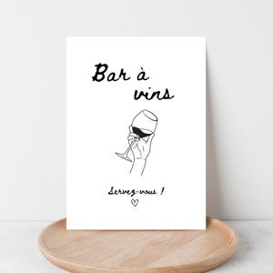 May include: Black and white illustration of a hand holding a glass of wine with the text "Bar à vins" and "Servez-vous!"  A heart symbol is below the text.