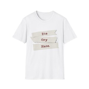 May include: White t-shirt with the words "Die Cry Hate." printed on it in red.