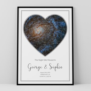 May include: A framed vertical poster featuring a heart-shaped star map with blue and orange nebula details. Below the heart, the text reads: The Night We Moved In, George & Sophia, August 24th, 2025, Harrogate, UK, 53.992° N, 1.542° W.