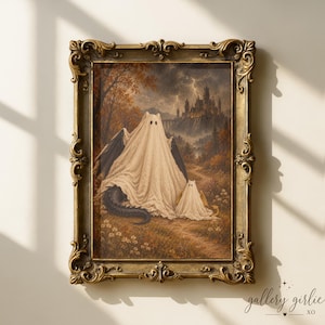 May include: A framed wall art print featuring a large and a small figure draped in white sheets, resembling ghosts, standing in a field with a dark castle and lightning in the background. The frame is ornate, metallic gold with intricate scrollwork.