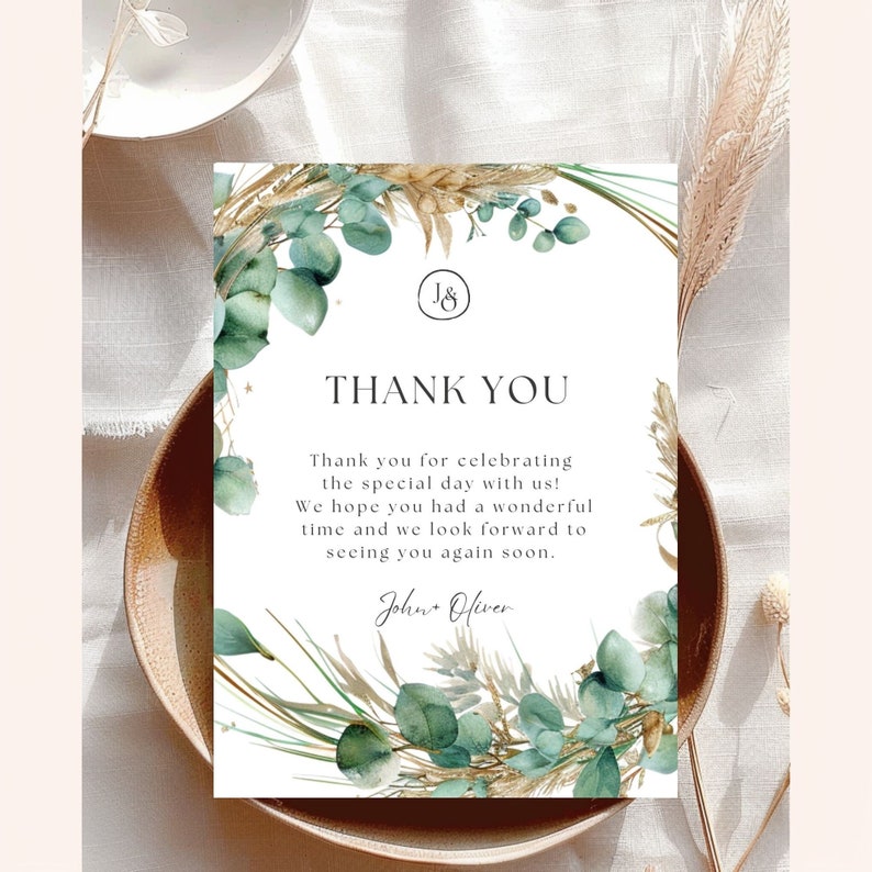 May include: A white thank you card with a green and gold floral design. The card says "Thank you" and "Thank you for celebrating the special day with us! We hope you had a wonderful time and we look forward to seeing you again soon." The card is signed "John Oliver".