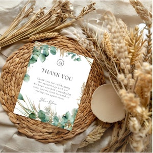 May include: A thank you card with a watercolor design of green leaves and beige grasses. The card has the text "Thank You" and "John Oliver" printed on it.