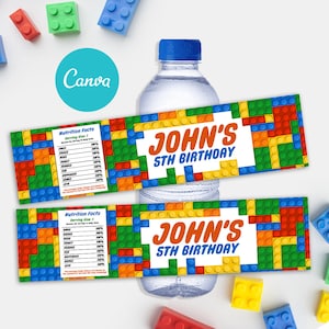 May include: A water bottle with a blue cap and two colorful labels. The labels feature a brick-like design in red, yellow, blue, and green, with the text "JOHN'S 5TH BIRTHDAY" in orange. One label includes a "Nutrition Facts" table.
