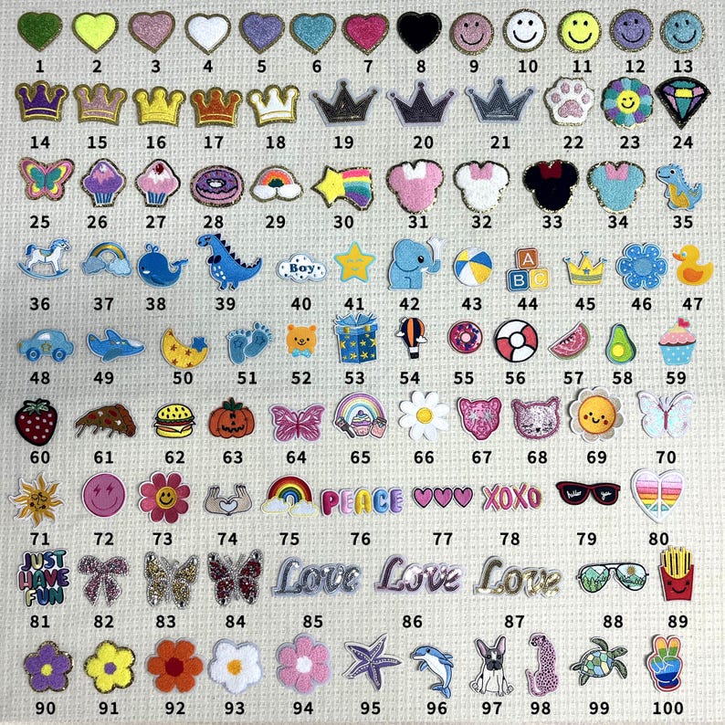 May include: A sheet of 100 iron-on patches featuring various designs, including hearts, crowns, animals, food, and words. The patches are colorful and come in a variety of shapes and sizes.