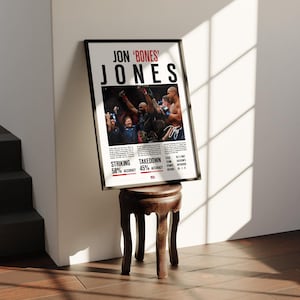 May include: A black and white poster with a photo of Jon "Bones" Jones, a mixed martial arts fighter, in the octagon. The poster includes text that says "Jon "Bones" Jones" and lists his striking and takedown accuracy percentages.