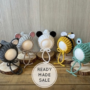 May include: A set of three ceramic nesting bowls with a speckled, off-white glaze. The bowls vary in size, with the largest measuring approximately 15 cm in diameter. Each bowl has a rounded shape and a simple, minimalist design.