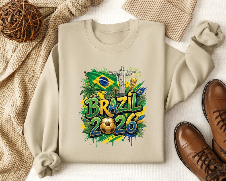 Crewneck sweatshirt with Brazil 2026 soccer graphic and Brazilian flag.