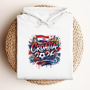 White hoodie with "Croatia 2026" graphic featuring a Croatian flag and soccer elements.