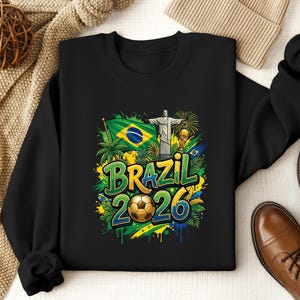 Black sweatshirt with Brazil flag, Christ the Redeemer, and "Brazil 2026" text.