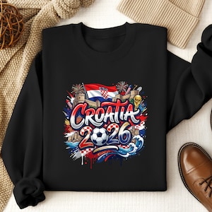Black sweatshirt with "Croatia 2026" text and flag elements.