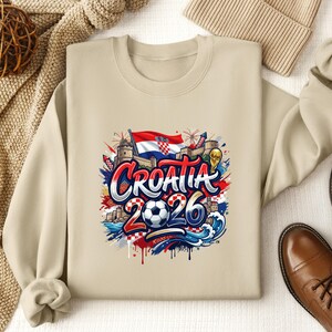 Crewneck sweatshirt with "Croatia 2026" text and soccer imagery.