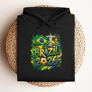 Black hoodie with "Brazil 2026" text, Brazilian flag, Christ the Redeemer, and soccer ball.