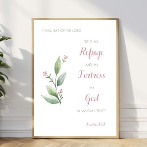 Pode incluir: Uma impressão emoldurada branca com um design floral em aquarela e o texto "Direi do Senhor: 'Ele é o meu refúgio e a minha fortaleza, o meu Deus em quem confio.' Salmo 91:2"