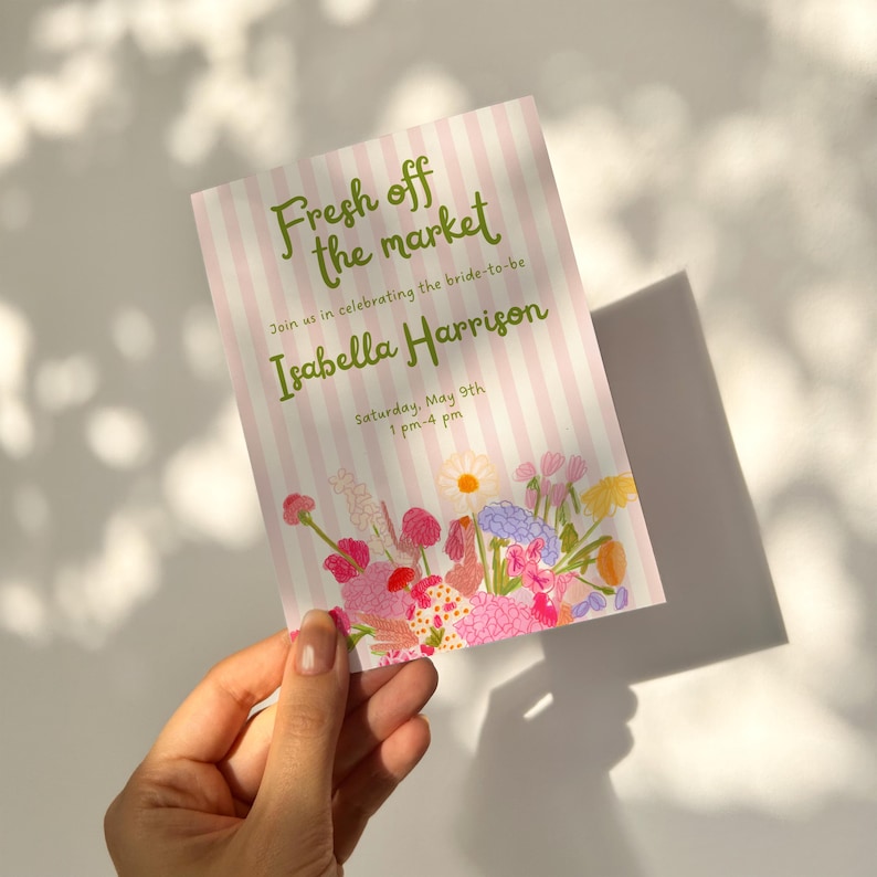 Editable bridal shower invitation template with "Fresh Off The Market" party theme. The invite has sage-green text, baby-pink stripes, and whimsical hand-drawn illustrations of flowers.