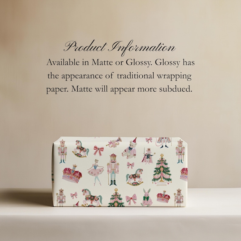 May include: Wrapping paper featuring a repeating pattern of nutcrackers, ballerinas, rocking horses, Christmas trees, crowns, and bows in pink, green, and gold on a cream background. Text reads: Product Information Available in Matte or Glossy.