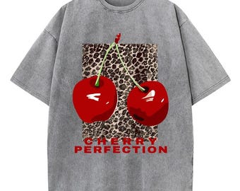 May include: A gray t-shirt with a graphic of two red cherries on a leopard print background. The text "CHERRY PERFECTION" is printed below the cherries.