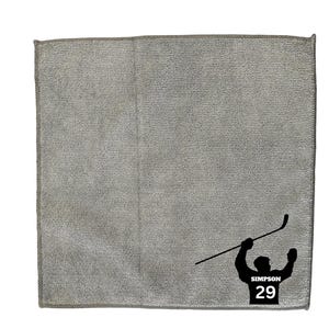 May include: Gray microfiber cleaning cloth with a black silhouette of a hockey player holding a hockey stick and the text "SIMPSON 29".
