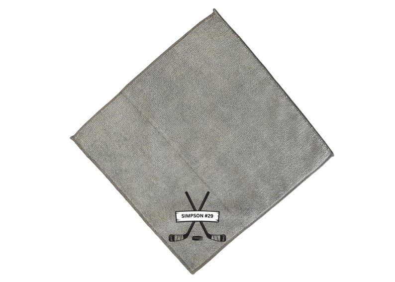 May include: Gray microfiber cleaning cloth with a black embroidered hockey stick design and the text "SIMPSON #29".