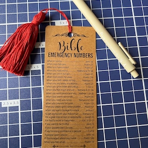 May include: A brown bookmark with the word "Bible" in a decorative font and the title "Emergency Numbers". The bookmark lists Bible verses for different situations, such as when you are in sorrow, when you have sinned, when you have worry, when you are in danger, when God seems far away, when your faith needs stirring, when you are lonely and fearful, when you grow bitter and critical, when you feel down and out, when you want peace and rest, when God seems too small, when you need assurance, when you prepare for travel, when your prayers grow narrow or selfish, when you want courage for a task, to get along with your fellowman, for a great intervention or opportunity, for Paul's secret to happiness, if you want to be fruitful, if your pocketbook is empty, if you're losing confidence in people, if people seem unkind, if discouraged about your work, when you feel small.