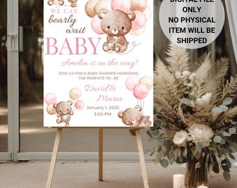 May include: A baby shower sign on an easel with a teddy bear theme. The sign reads "We can bearly wait BABY Amelia is on the way!" with the names David & Maria and the date January 1, 2025. The sign is decorated with teddy bear illustrations and balloons.