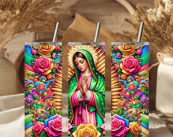 May include: Three stainless steel tumblers with colorful floral and religious designs. The center tumbler features an image of a woman with a halo, wearing a green and pink robe, with hands clasped in prayer. The other two tumblers have vibrant floral patterns.