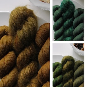 May include: Four skeins of yarn in shades of green and brown. The yarn is arranged in a circle on a white surface.