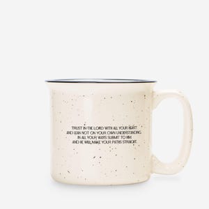 May include: A cream-coloured ceramic mug with a speckled finish and a dark rim. The front features black text that reads: Trust in the Lord with all your heart and lean not on your own understanding; in all your ways submit to him, and he will make your paths straight.