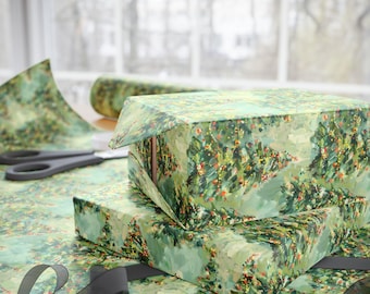 May include: Two boxes wrapped in green and white Christmas wrapping paper with a watercolor-style design of Christmas trees. The boxes are stacked on top of each other and there is a black ribbon on the bottom box.