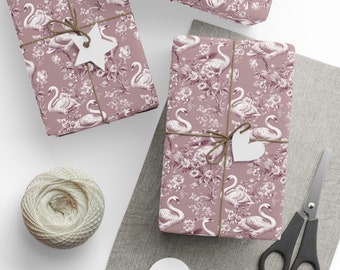 May include: Several wrapped gifts with a mauve swan and floral pattern. Each package is tied with twine and a white tag. A ball of twine, scissors, and blank tags are also visible.