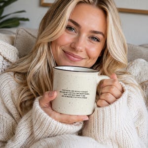 May include: A cream-coloured ceramic mug with a speckled finish and a black rim. The mug features black printed text that reads: Trust in the Lord with all your heart and lean not on your own understanding; in all your ways submit to him, and he will make your paths straight.