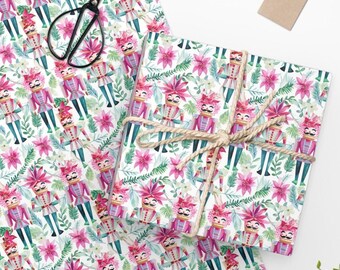 May include: White wrapping paper with a repeating pattern of pink poinsettia flowers, green leaves, and watercolour nutcracker soldiers. The nutcrackers are wearing pink and blue uniforms with gold accents.