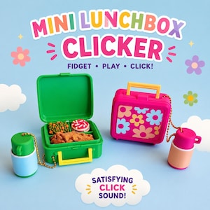 May include: Two mini lunchbox fidget clickers with gold ball chains. One is open, revealing green peas, a donut, and a fried food item. The other is closed, featuring a pink exterior with a multi-colored flower pattern and a yellow handle.