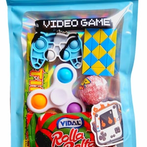 May include: A blue zippered pouch with a clear window showing a variety of small toys and sweets. The toys include a blue and white fidget toy shaped like a video game controller, a white fidget spinner, a yellow and blue puzzle, and a red lollipop. The sweets are a red and green wrapped candy bar with the text "Vidal Rolla Bella" on it. There is also a sticker of a video game console with flames on it.
